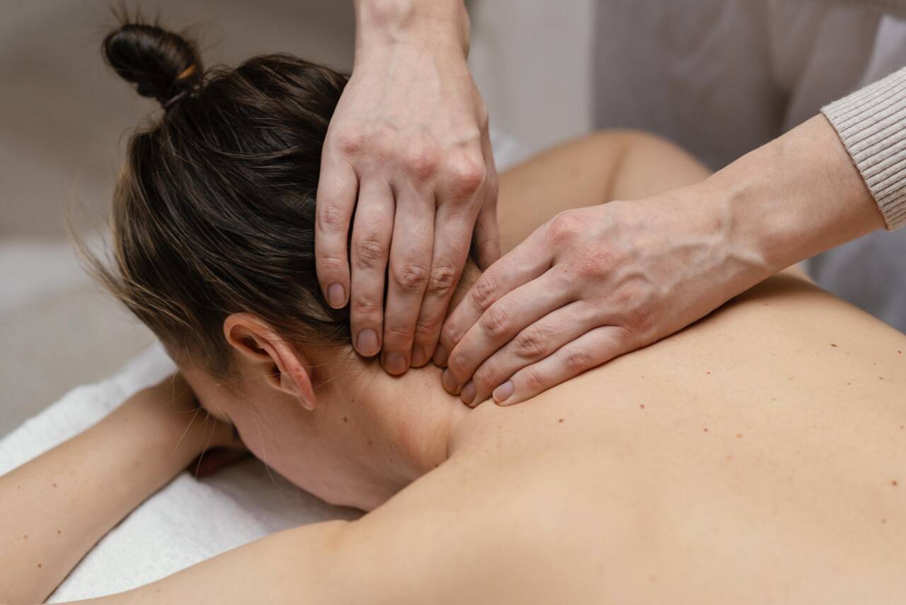 close-up-therapist-massaging-neck